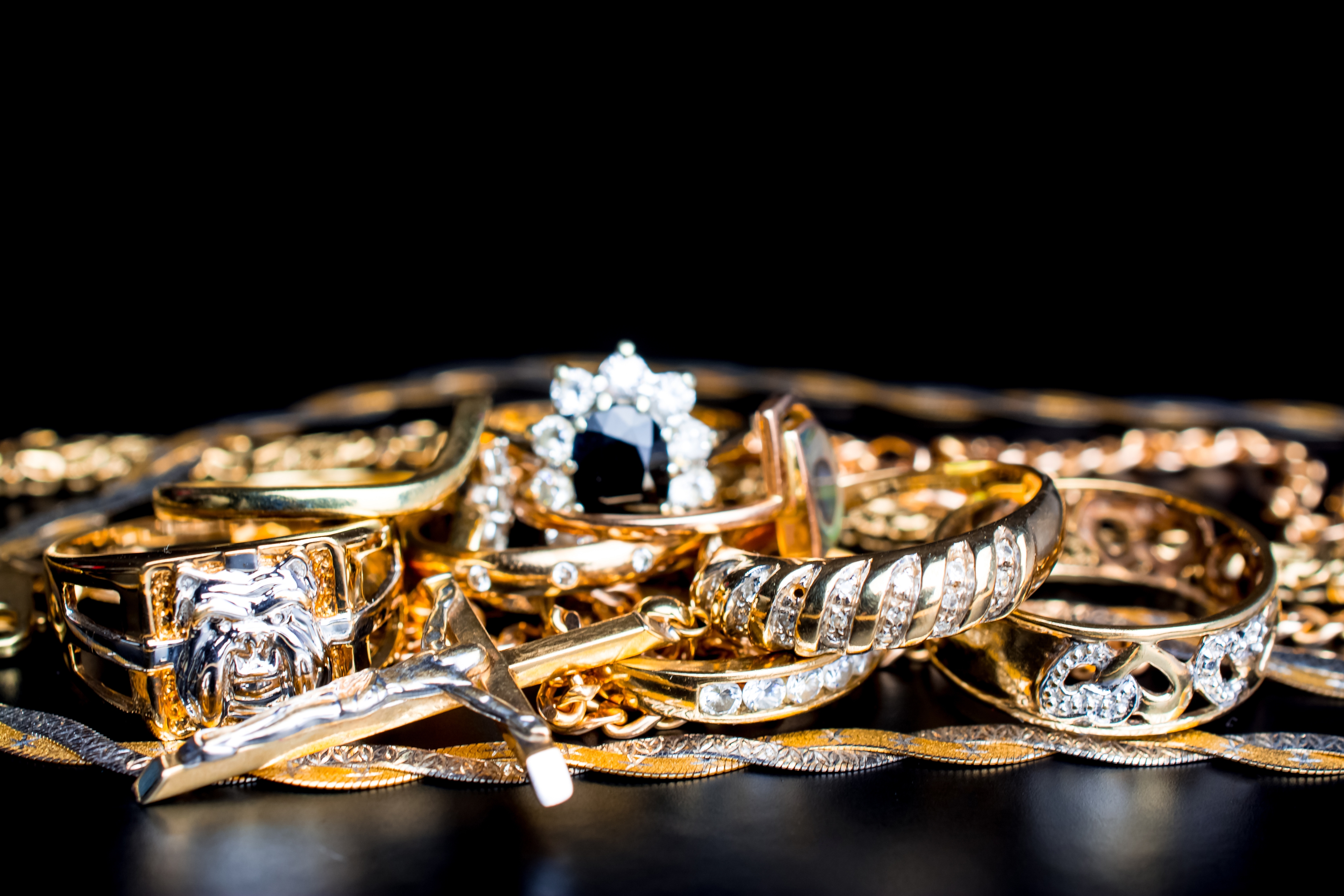 Gold and diamond jewelry on black background